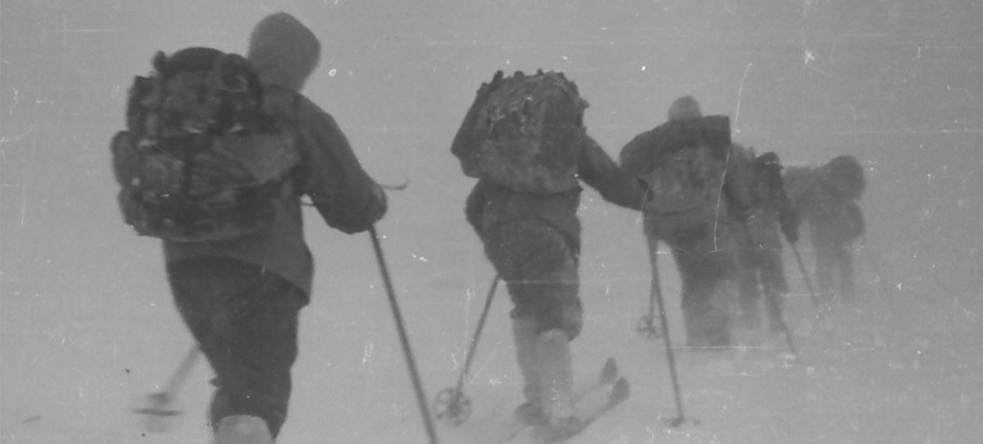 Black and white photo of explorers on cross country skis